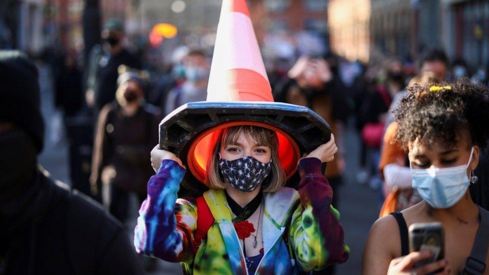 Woman with a traffic cone on her head