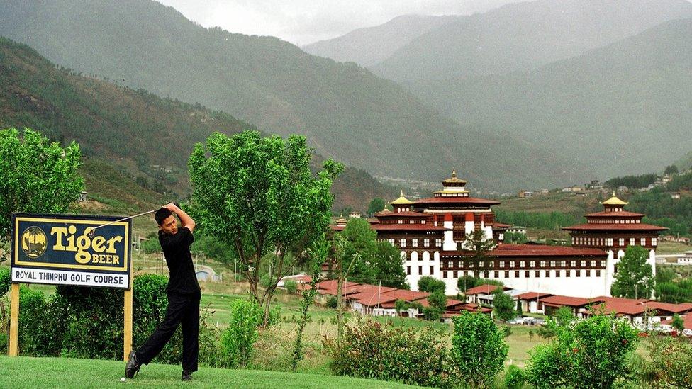 Man plays golf in Bhutan