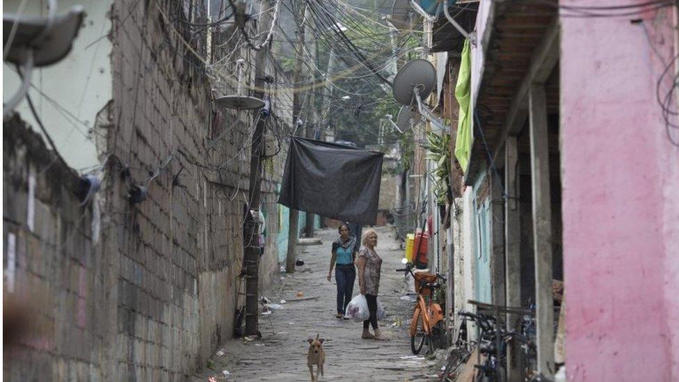 A black banner hangs at the entrance of the Morro da Providencia favela, to mourn the death of teenager Eduardo Felipe Santos Victor, in Rio de Janeiro, Brazil, on 30 September 2015