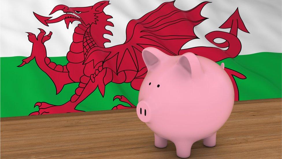 Piggybank in front of Welsh Flag