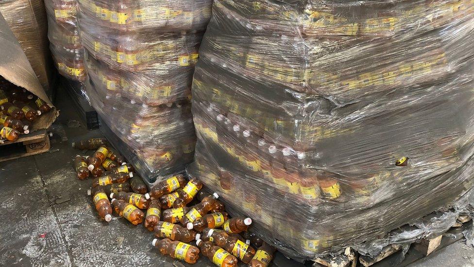 Palettes filled with bottles of soda in French customs warehouse