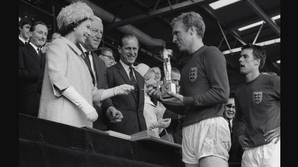 Bobby-Moore-collects-the-World-Cup-Jules-Rimet-Trophy-from-Queen-Elizabeth-II-back-in-1966.