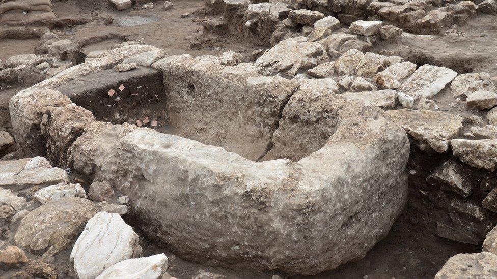 A stone basin that looks similar in shape to a tub