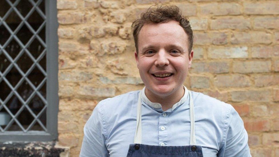 A chef smiling at the camera