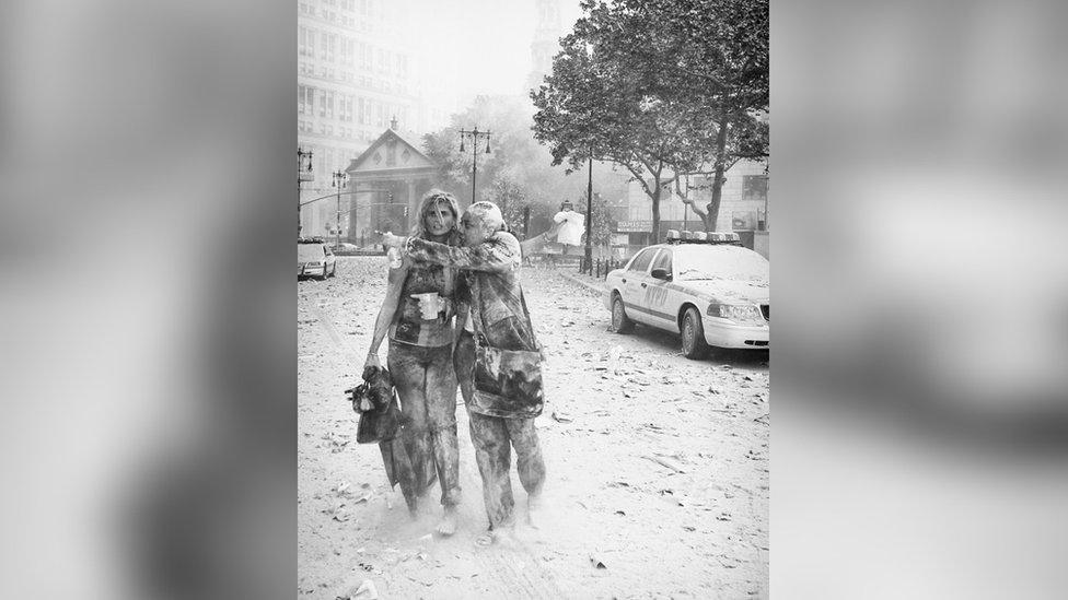 Two people covered in ash