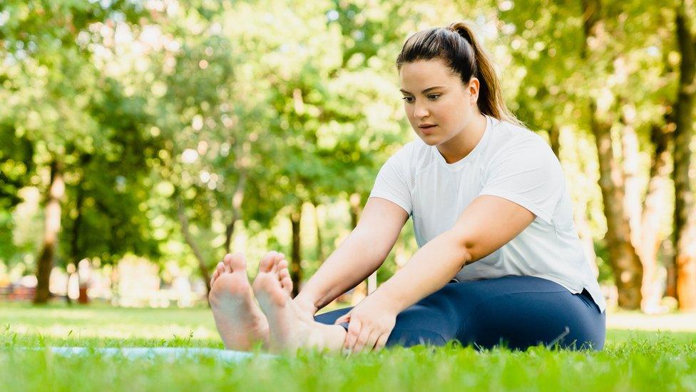 Woman exercising in a park