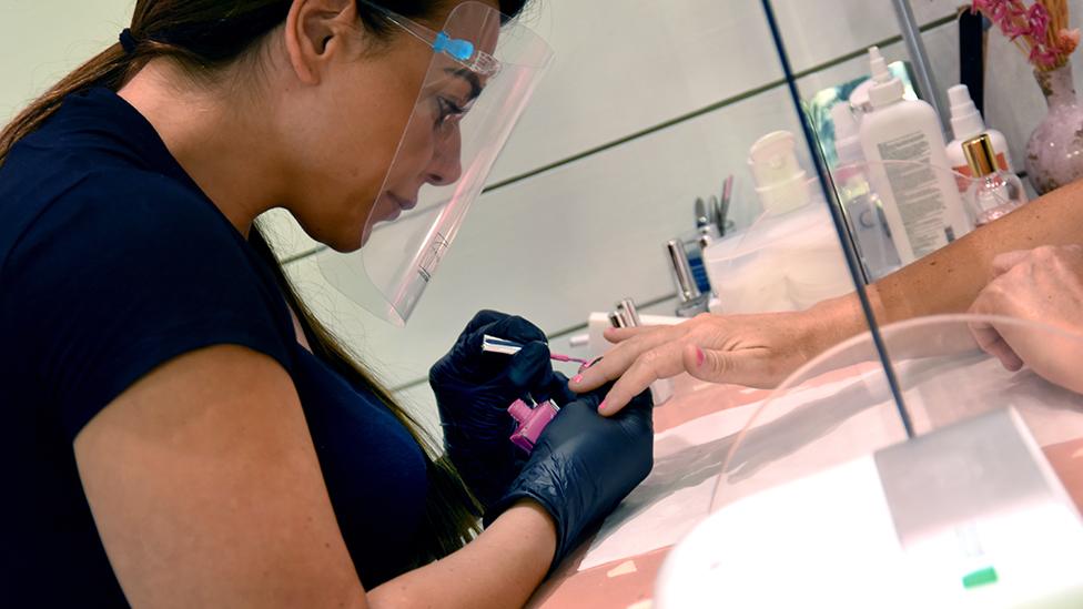 Nail technician Babs works on Luce's nails.