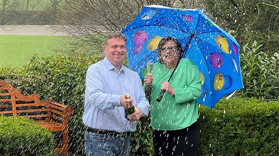 Richard Nuttall popping open the champagne with wife Debbie