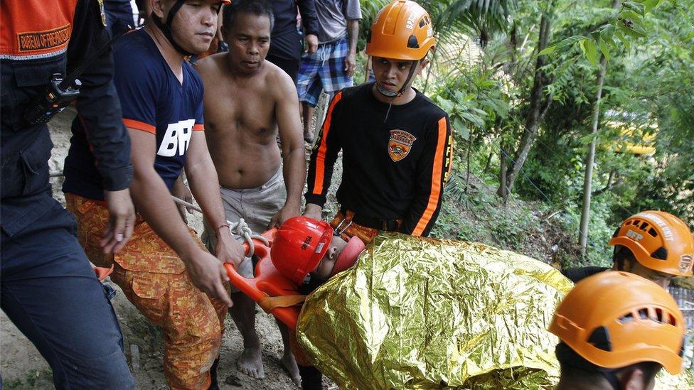 Rescue workers bringing an injured from the rubble