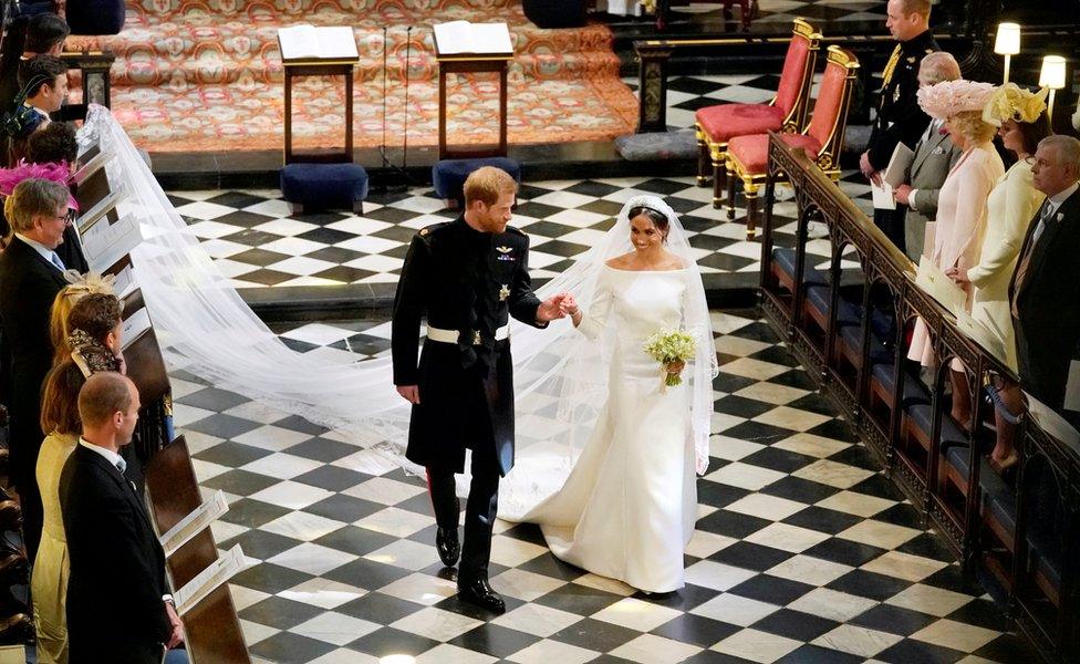 Prince Harry and Meghan Markle depart from St George's Chapel in Windsor Castle after their wedding