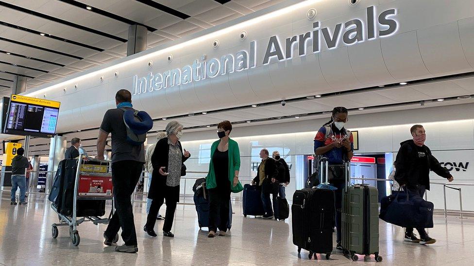 Passengers wearing masks at Heathrow's international arrivals area