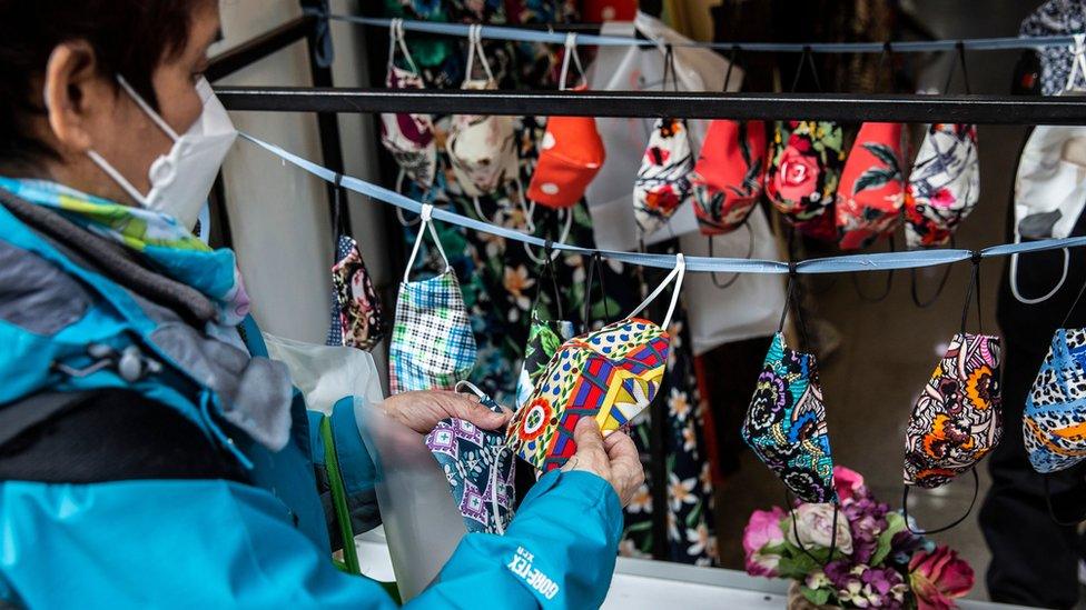 Shopper in Hong Kong inspects colourful masks