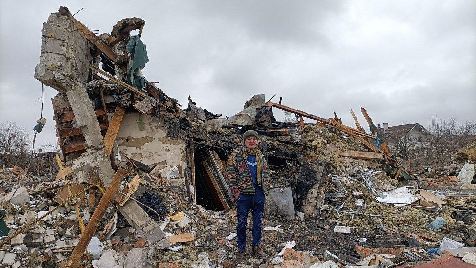 Man outside destroyed building