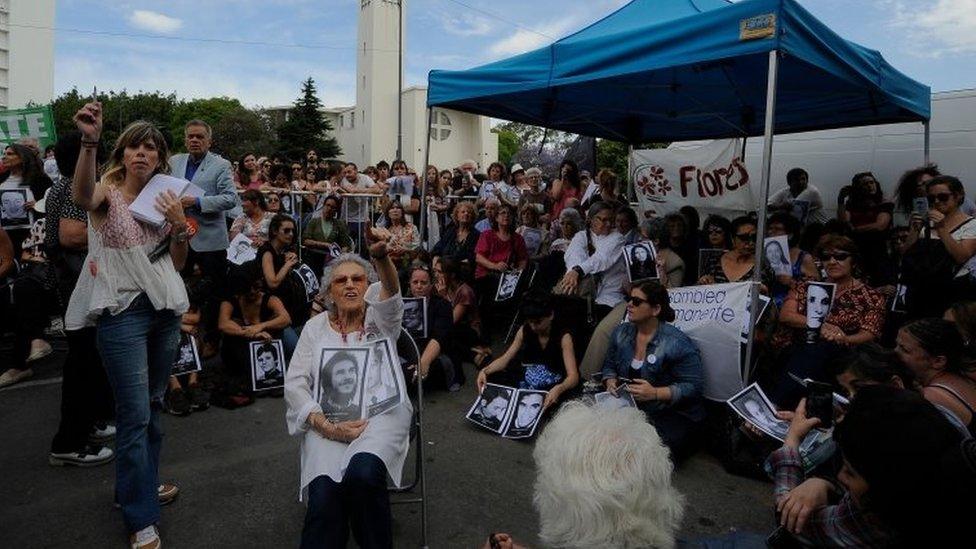 Lita Boitano (C), president of Human Rights organization "Families of the Disappeared and Detained for Political Reasons" follows on a giant screen the sentencing hearing for crimes against humanity committed during the last Argentine military dictatorship, in Buenos Aires on November 29, 2017.