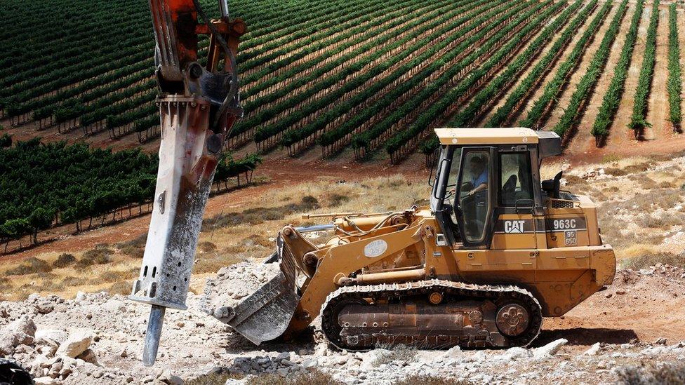 A bulldozer break ground for the new Jewish settlement of Amichai in the occupied West Bank (20 June 2017)