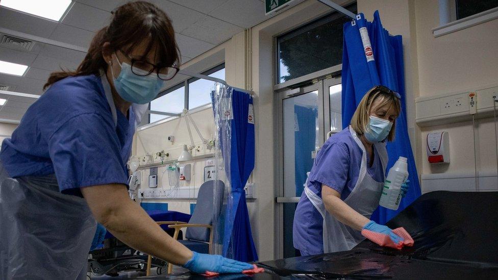 Nurses sterilise a short stay bed after a patient has been discharged