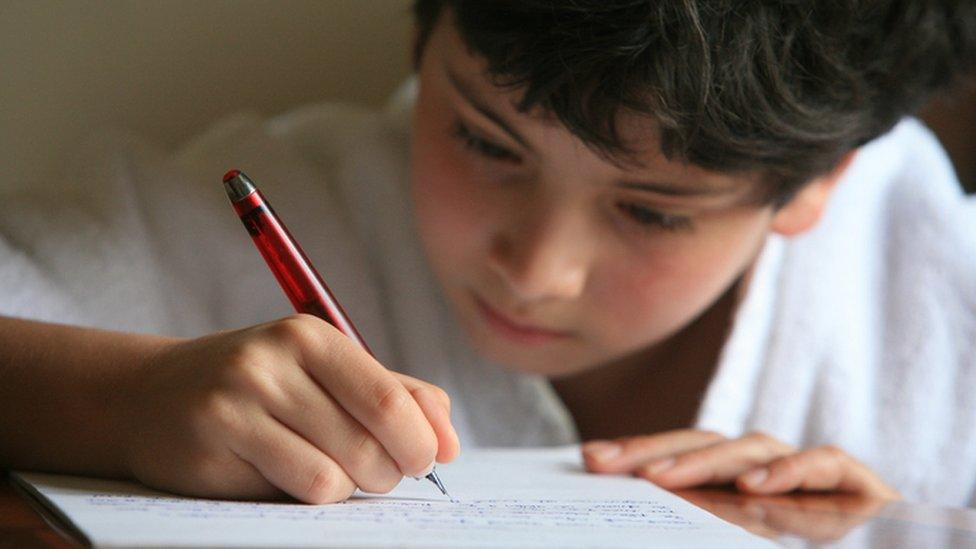 Boy writing on paper