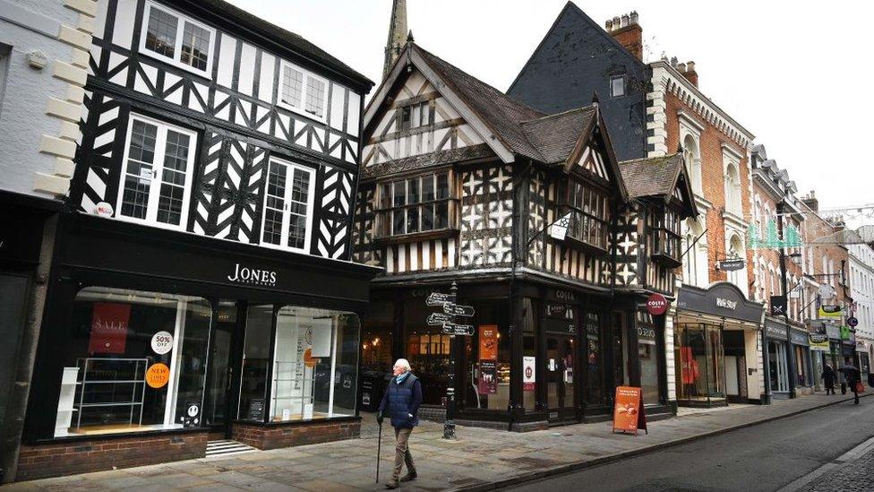 An elderly man walks through Shrewsbury town centre