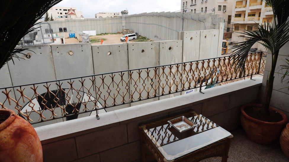 A picture taken from street artist Banksy"s newly opened Walled Off hotel in the Israeli occupied West Bank town of Bethlehem, on March 3, 2017, shows Israel"s controversial separation wall.