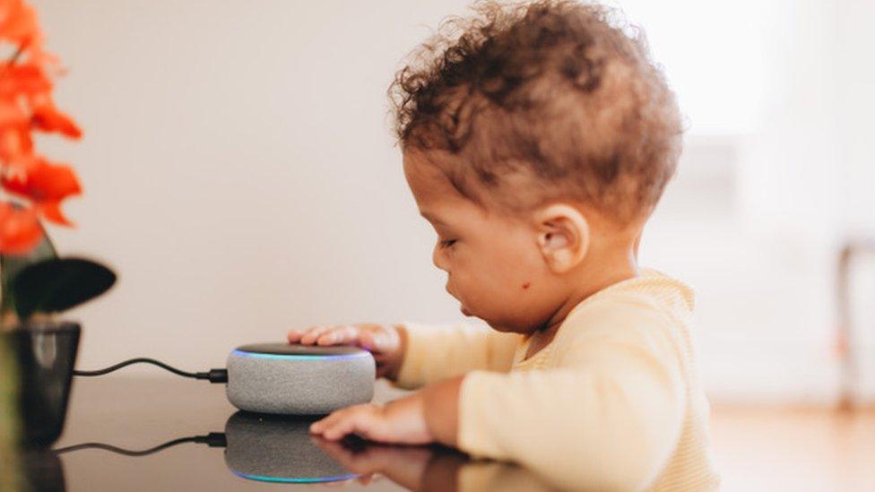 Toddler next to an Amazon Dot