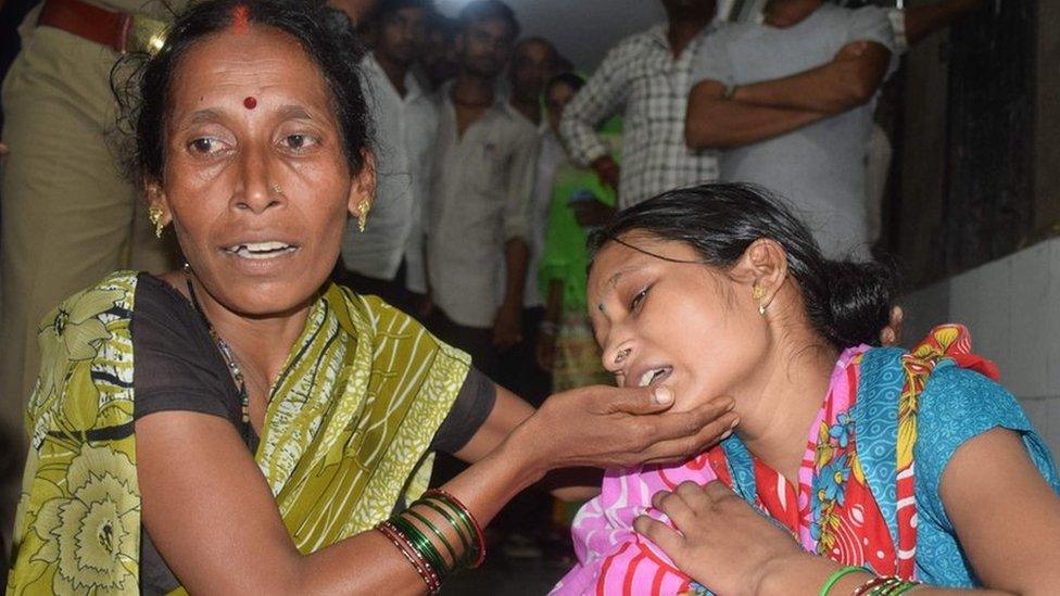 Relatives mourn the death of a children at Baba Raghav Das Hospital in Gorakhpur district of the Indian northern state Uttar Pradesh