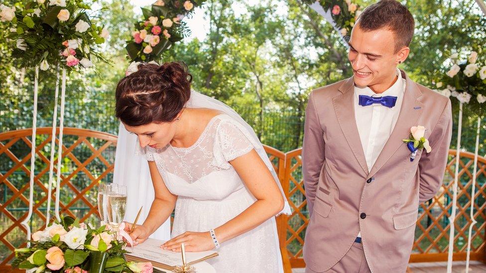 Married couple signing the Register