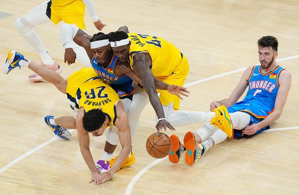 Oklahoma City Thunder's Luguentz Dort battles for a loose ball with Indiana Pacers' Ben Sheppard and Pascal Siakam during the third quarter of the 2025 NBA Finals in Indianapolis. Photo by Dylan Buell