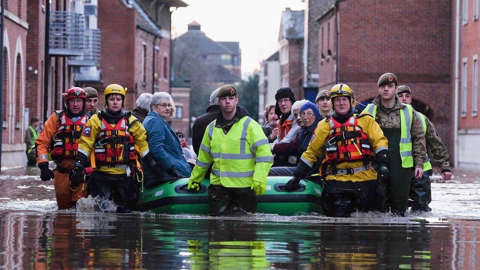 Mountain Rescue teams and soldiers help people to evacuate their homes in York as flood waters rise.