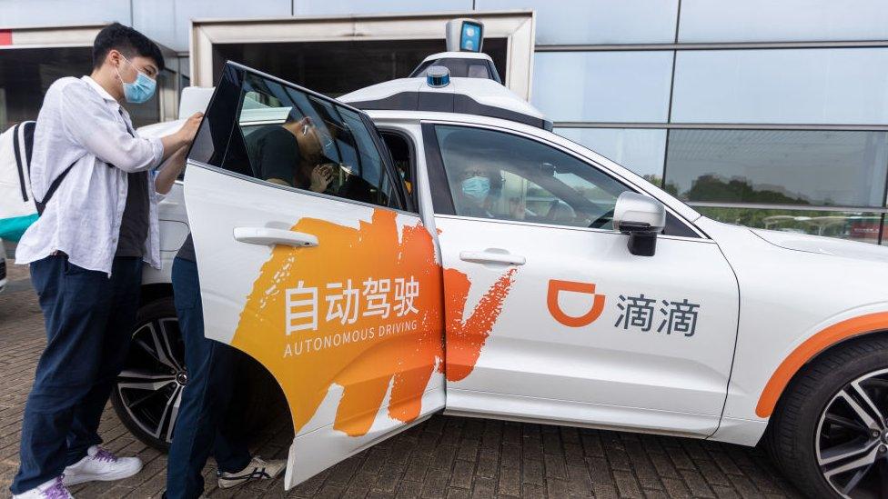 A passenger tries out DiDi autonomous driving robotaxi