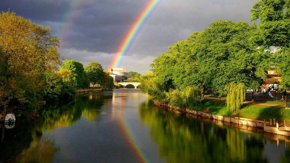 A double rainbow reflected in water