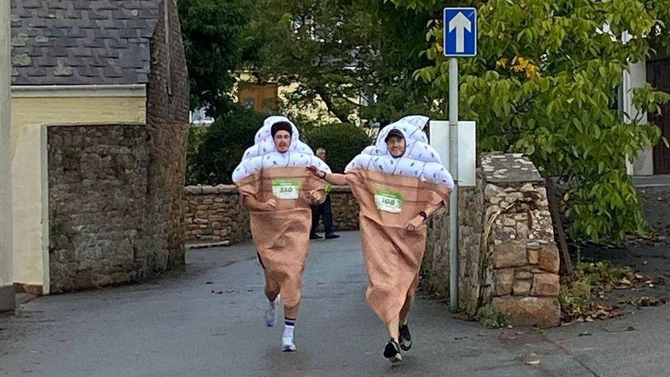 Two men dressed as ice creams running a marathon