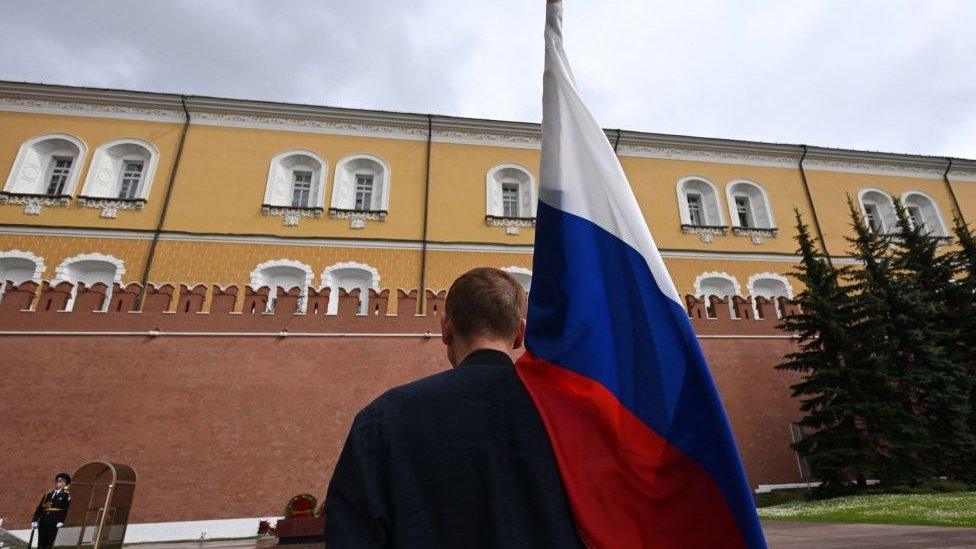 man-holding-russian-flag.