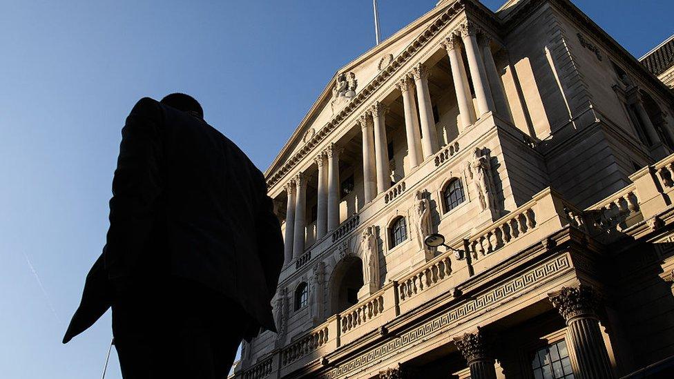 City worker walks in front of Bank of England