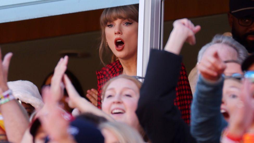 Taylor Swift with mouth agape in the crowd