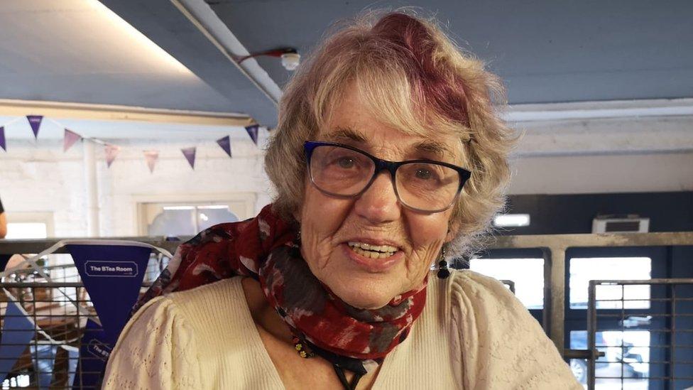 An older woman in a cafe