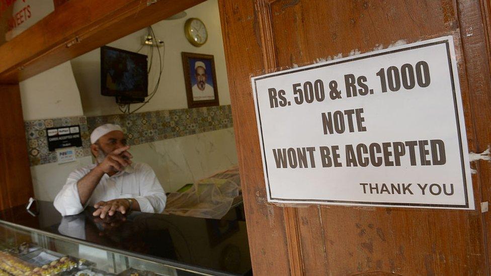 A shop owner in Mumbai displays a notice of non-acceptance of old Rs500 and Rs1000 currency notes