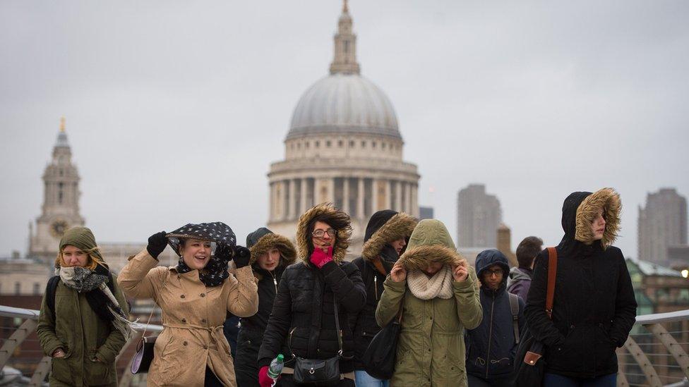 People experience high winds as they cross the Millennium Bridge in London, as winds of nearly 100mph battered parts of Britain after Storm Imogen slammed into the south coast bringing fierce gusts and torrential downpours