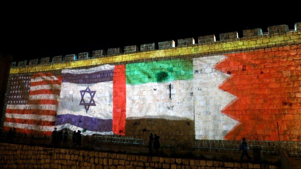 The flags of the United States, Israel, United Arab Emirates and Bahrain are projected on a section of the walls surrounding Jerusalem's Old City