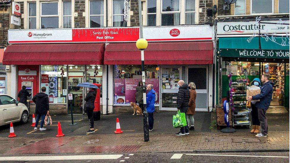 People queue for a post office on Sandy park Road, Bristol