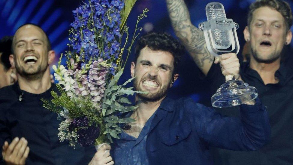 The Netherlands' Duncan Laurence holds up the eurovision glass microphone trophy