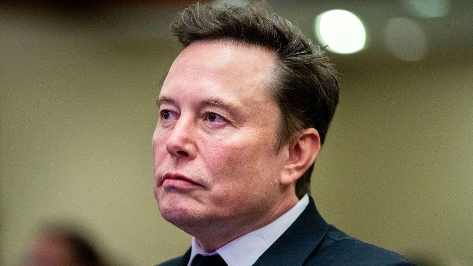 Elon Musk in a suit