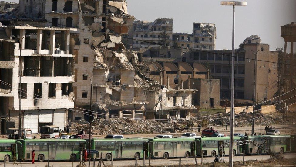 Buses wait in Ramousseh, Aleppo, 15 Dec