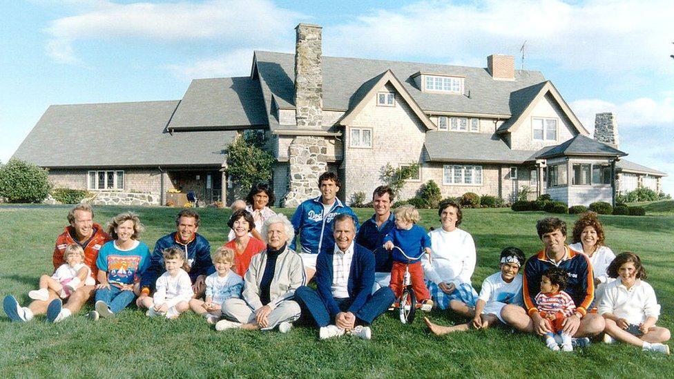 Former US President George HW Bush and his family pose outside their Kennebunkport, Maine, home.