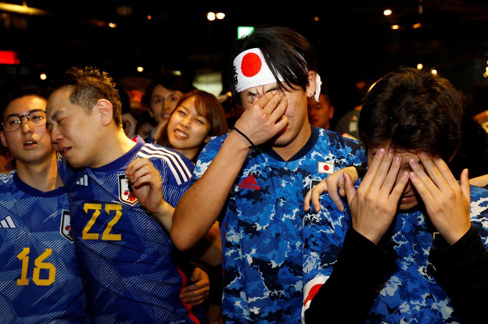 Fans in Tokyo react during the penalty shoot out between Japan and Croatia at the football World Cup, 6 December 2022