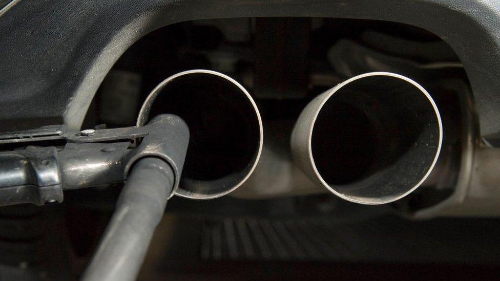 A hose for an emission test is fixed in the exhaust pipe of a Volkswagen Golf 2 litre diesel car at the Technical Inspection Agency in Ludwigsburg, southwestern Germany, on August 7, 2017