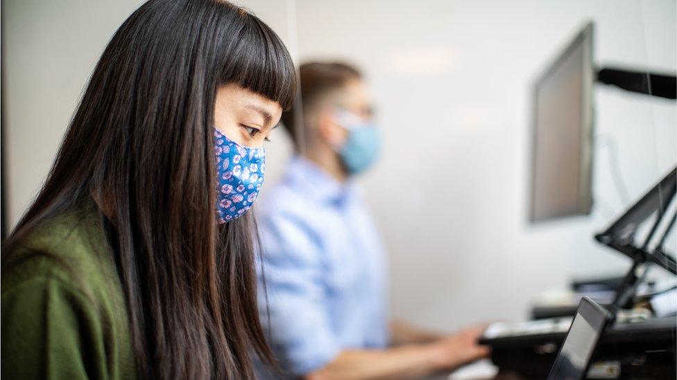 A female worker wearing a mask