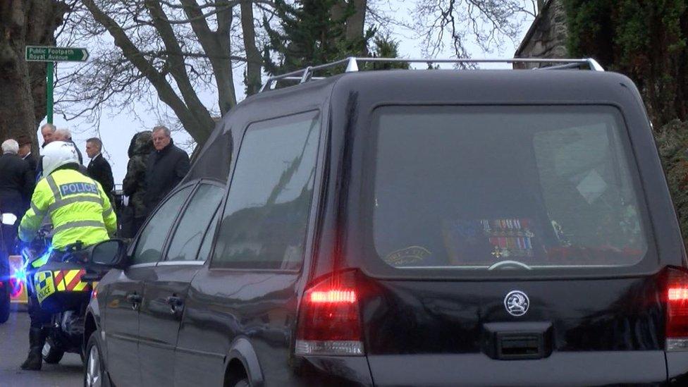 Police motorcyclist leading the hearse