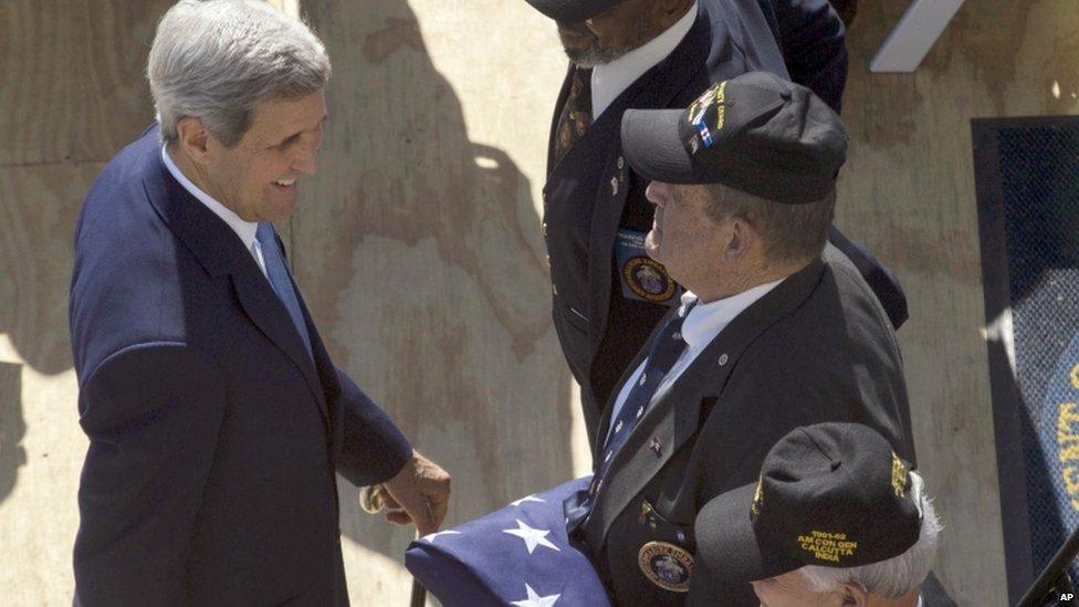 US Secretary of State John Kerry greets the three Marines who lowered the flag at the US embassy's closing in 1961 on 14 August 2015.