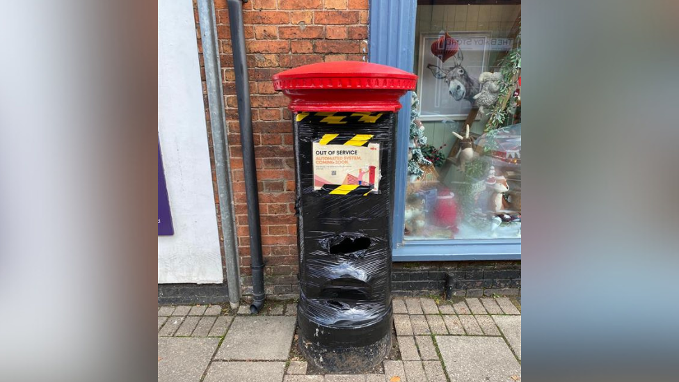 Postbox in Syston, covered in black tape 