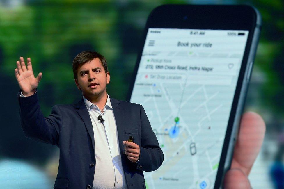 Indian Ola app co-founder and CEO Bhavish Aggarwal gestures as he addresses a press conference in Bangalore on November 22, 2016.